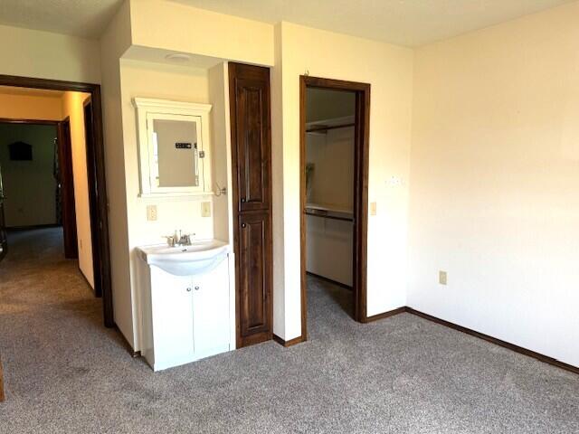 2604 Country Dr, Mountain Grove, MO 65711 - unfurnished bedroom featuring light colored carpet, a closet, and a spacious closet