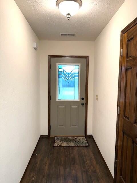 2604 Country Dr, Mountain Grove, MO 65711 - doorway featuring a textured ceiling and dark wood-style floors