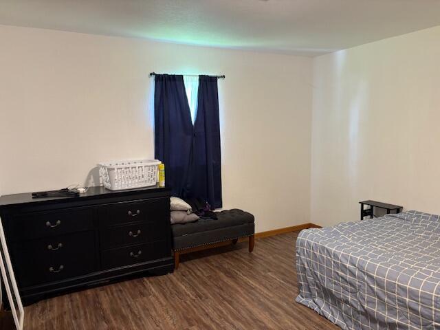 117 E Springfield St, Aurora, MO 65605 - bedroom featuring dark wood-style floors and baseboards