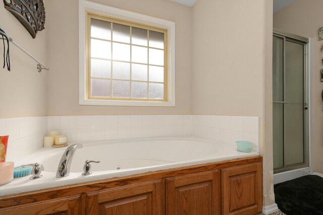 3223 W Melbourne St, Springfield, MO 65810 - bathroom featuring a tub with jets and a stall shower
