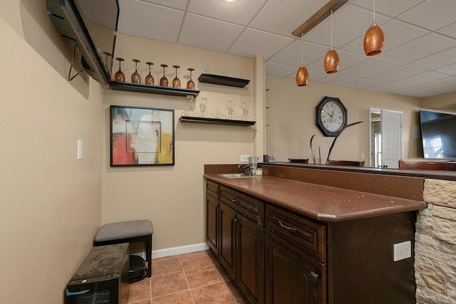 3223 W Melbourne St, Springfield, MO 65810 - kitchen featuring dark countertops, a paneled ceiling, open shelves, dark brown cabinetry, and light tile patterned floors