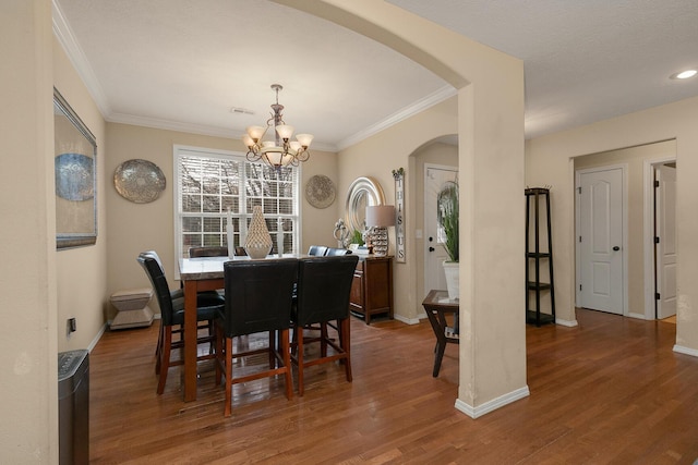 3223 W Melbourne St, Springfield, MO 65810 - dining area featuring arched walkways, a chandelier, wood finished floors, and ornamental molding