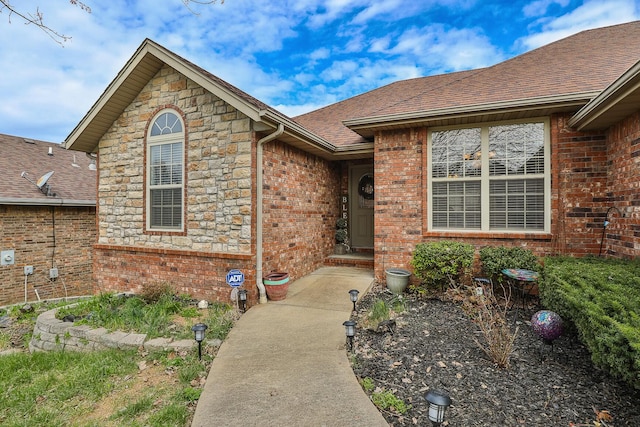 3223 W Melbourne St, Springfield, MO 65810 - view of exterior entry with brick siding, roof with shingles, and stone siding