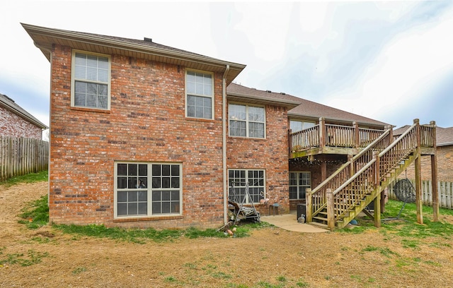 3223 W Melbourne St, Springfield, MO 65810 - back of property featuring a wooden deck, stairs, and brick siding