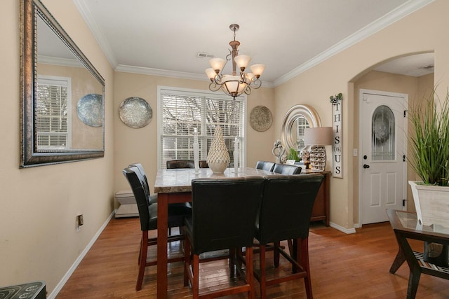 3223 W Melbourne St, Springfield, MO 65810 - dining room featuring a chandelier, wood finished floors, plenty of natural light, and crown molding