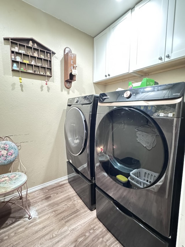 3517 Hackberry Ln, Joplin, MO 64801 - washroom featuring cabinet space, washing machine and dryer, and light wood-style flooring