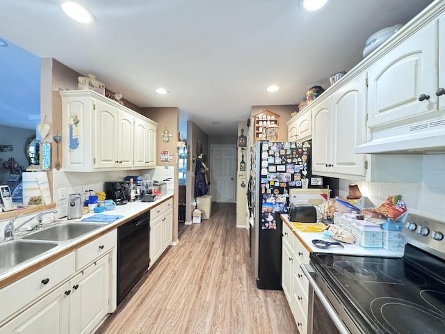 3517 Hackberry Ln, Joplin, MO 64801 - kitchen with stainless steel range with electric cooktop, black dishwasher, under cabinet range hood, light wood finished floors, and white cabinetry