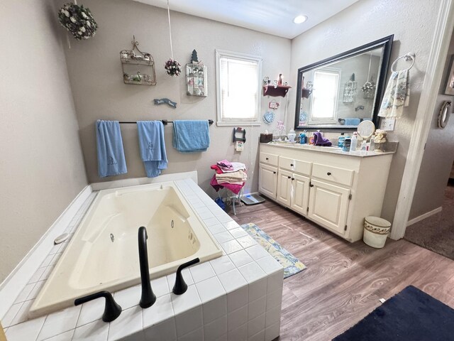 3517 Hackberry Ln, Joplin, MO 64801 - bathroom with vanity, wood finished floors, a whirlpool tub, and recessed lighting