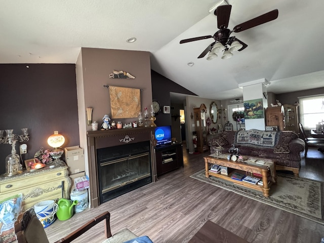 3517 Hackberry Ln, Joplin, MO 64801 - living area featuring ceiling fan, lofted ceiling, a glass covered fireplace, and wood finished floors