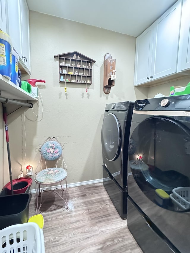3517 Hackberry Ln, Joplin, MO 64801 - washroom with washing machine and clothes dryer, cabinet space, and light wood-style floors