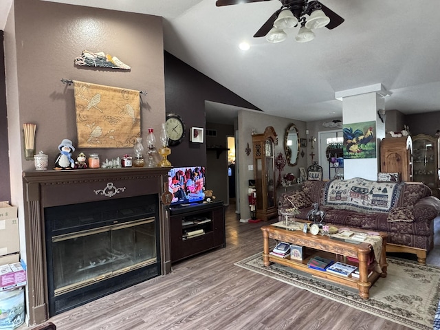 3517 Hackberry Ln, Joplin, MO 64801 - living room featuring a ceiling fan, vaulted ceiling, wood finished floors, and a glass covered fireplace