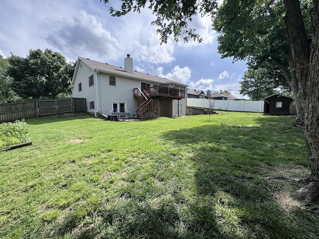 3517 Hackberry Ln, Joplin, MO 64801 - fenced backyard featuring stairs, a deck, and a storage shed