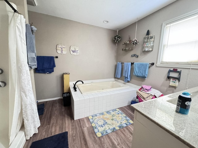 3517 Hackberry Ln, Joplin, MO 64801 - bathroom featuring a garden tub, wood finished floors, vanity, and curtained shower