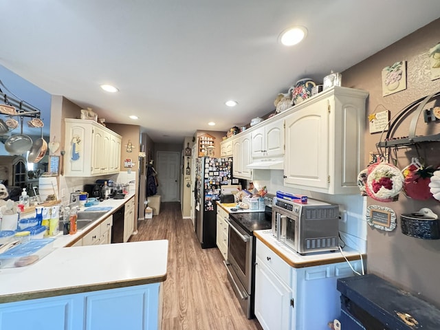 3517 Hackberry Ln, Joplin, MO 64801 - kitchen featuring appliances with stainless steel finishes, under cabinet range hood, light wood-type flooring, light countertops, and recessed lighting