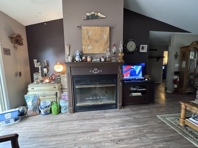 3517 Hackberry Ln, Joplin, MO 64801 - living area featuring a glass covered fireplace, wood finished floors, and lofted ceiling