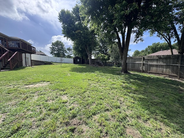 3517 Hackberry Ln, Joplin, MO 64801 - fenced backyard with stairway, a shed, and a wooden deck