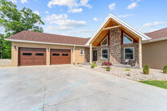 770 Mills Hollow Rd, Branson, MO 65616 - mid-century home featuring driveway, stucco siding, an attached garage, and stone siding