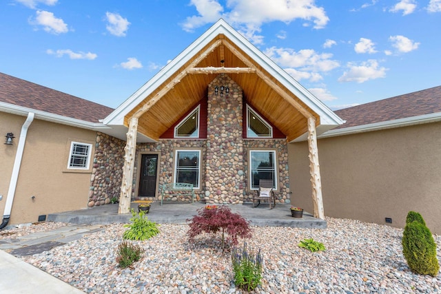 770 Mills Hollow Rd, Branson, MO 65616 - property entrance with stone siding, stucco siding, covered porch, and roof with shingles