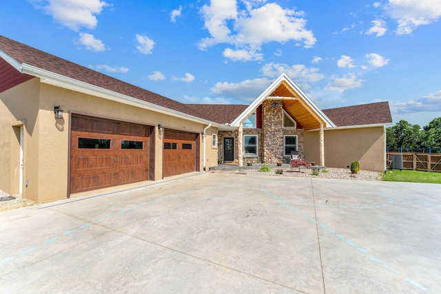 770 Mills Hollow Rd, Branson, MO 65616 - view of front of house featuring stucco siding, driveway, and a garage
