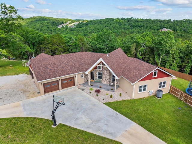 770 Mills Hollow Rd, Branson, MO 65616 - view of front of home with a wooded view, driveway, stucco siding, a garage, and stone siding