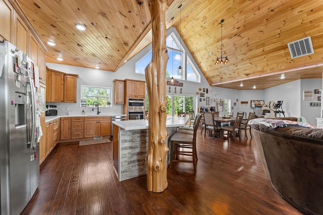 770 Mills Hollow Rd, Branson, MO 65616 - kitchen with stainless steel appliances, open floor plan, light countertops, a breakfast bar, and high vaulted ceiling