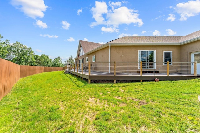 770 Mills Hollow Rd, Branson, MO 65616 - rear view of house featuring stucco siding, a deck, a fenced backyard, and a shingled roof
