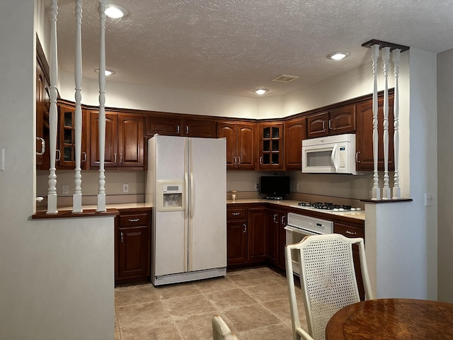 3454 W Countryside Dr, Springfield, MO 65807 - kitchen featuring white appliances, glass insert cabinets, a textured ceiling, recessed lighting, and light countertops