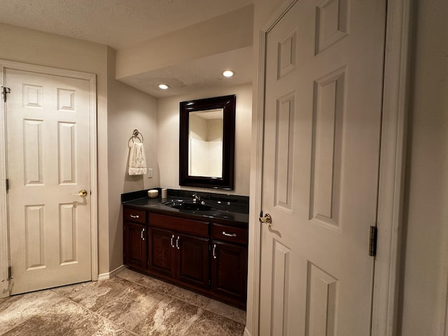 3454 W Countryside Dr, Springfield, MO 65807 - bathroom with vanity, a textured ceiling, and recessed lighting