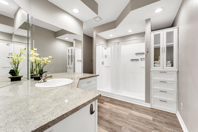 280 W Woodland Dr Unit Ld, Branson, MO 65616 - full bathroom featuring vanity, tiled shower, wood finished floors, and recessed lighting