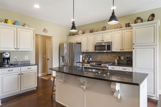 715 S Oak Terrace Dr, Nixa, MO 65714 - kitchen with stainless steel appliances, decorative backsplash, a breakfast bar area, dark wood finished floors, and recessed lighting
