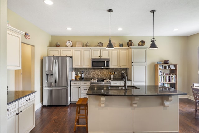 715 S Oak Terrace Dr, Nixa, MO 65714 - kitchen featuring appliances with stainless steel finishes, dark wood-style floors, a breakfast bar, tasteful backsplash, and recessed lighting
