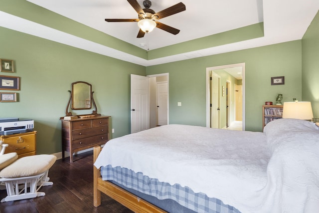 715 S Oak Terrace Dr, Nixa, MO 65714 - bedroom featuring wood finished floors, a tray ceiling, and a ceiling fan