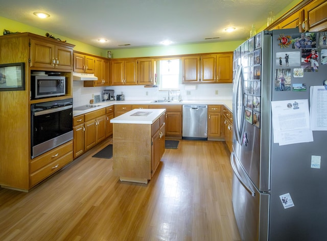 9396 Lawrence Unit 2040, Miller, MO 65707 - kitchen with stainless steel appliances, light countertops, a kitchen island, backsplash, and recessed lighting
