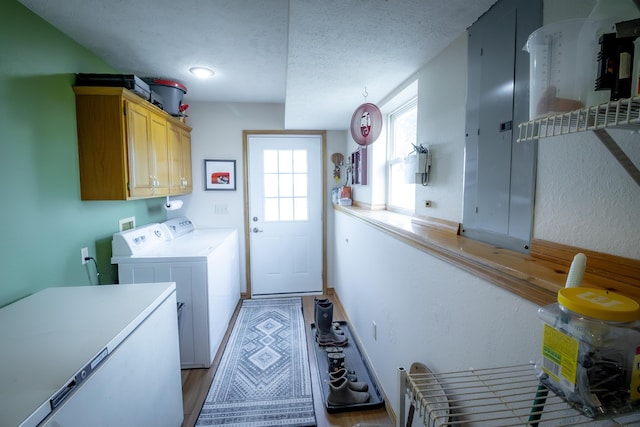 9396 Lawrence Unit 2040, Miller, MO 65707 - washroom featuring cabinet space, independent washer and dryer, electric panel, a textured ceiling, and light wood-style floors