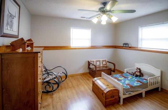 9396 Lawrence Unit 2040, Miller, MO 65707 - bedroom featuring wood finished floors and a ceiling fan