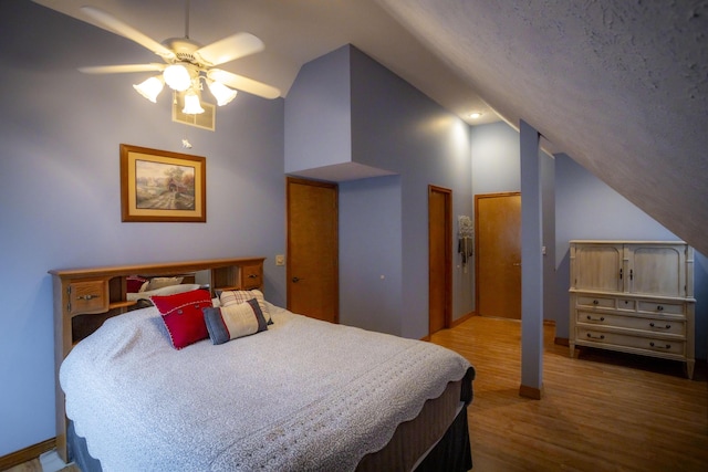 9396 Lawrence Unit 2040, Miller, MO 65707 - bedroom with wood finished floors, ceiling fan, high vaulted ceiling, and multiple closets