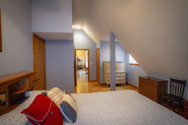 9396 Lawrence Unit 2040, Miller, MO 65707 - bedroom featuring wood finished floors and lofted ceiling