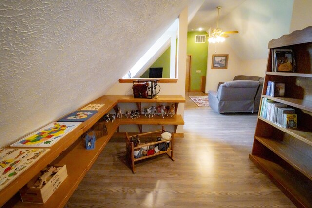 9396 Lawrence Unit 2040, Miller, MO 65707 - additional living space with wood finished floors, a textured ceiling, a ceiling fan, and vaulted ceiling