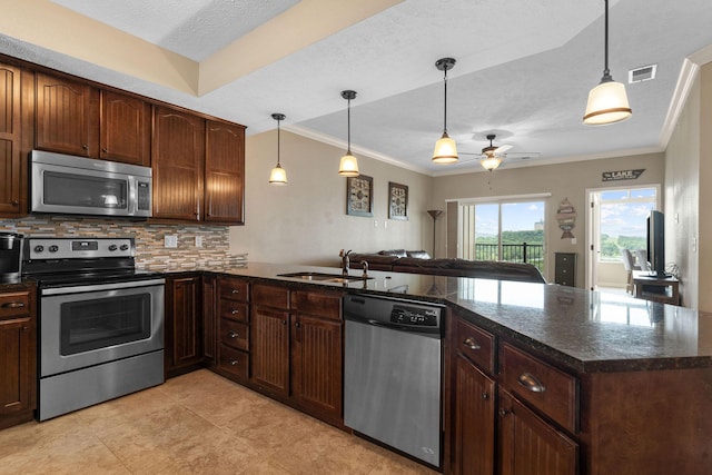 200 Majestic Dr Unit 1-303, Branson, MO 65616 - kitchen featuring appliances with stainless steel finishes, a ceiling fan, a peninsula, backsplash, and ornamental molding