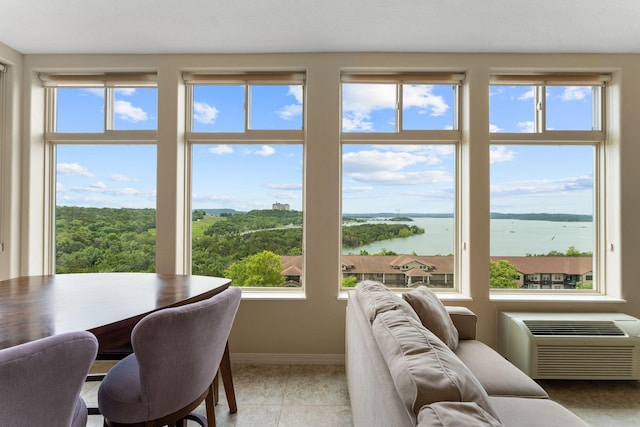 200 Majestic Dr Unit 1-303, Branson, MO 65616 - dining space featuring a water view, plenty of natural light, and a wall mounted air conditioner