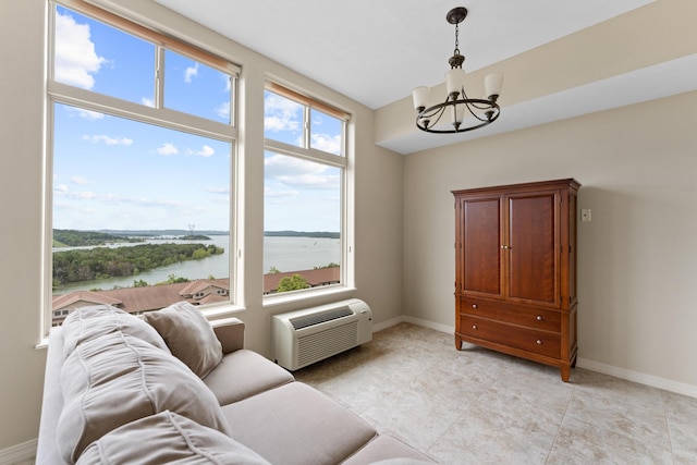 200 Majestic Dr Unit 1-303, Branson, MO 65616 - sitting room featuring a chandelier, a water view, an AC wall unit, and light tile patterned floors