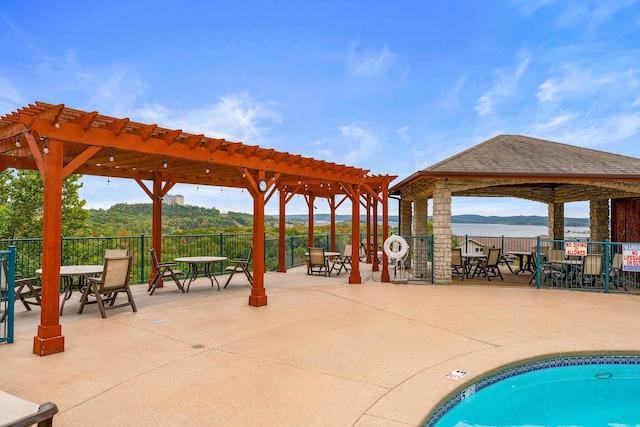 200 Majestic Dr Unit 1-303, Branson, MO 65616 - view of swimming pool with a pergola, a gazebo, outdoor dining space, a water view, and a patio area