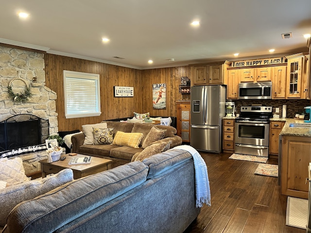 14 Little Creek Ln, Kimberling City, MO 65686 - living area featuring ornamental molding, dark wood finished floors, a stone fireplace, wood walls, and recessed lighting