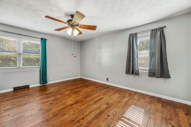 829 W Highland St, Springfield, MO 65807 - empty room with hardwood / wood-style floors and a ceiling fan