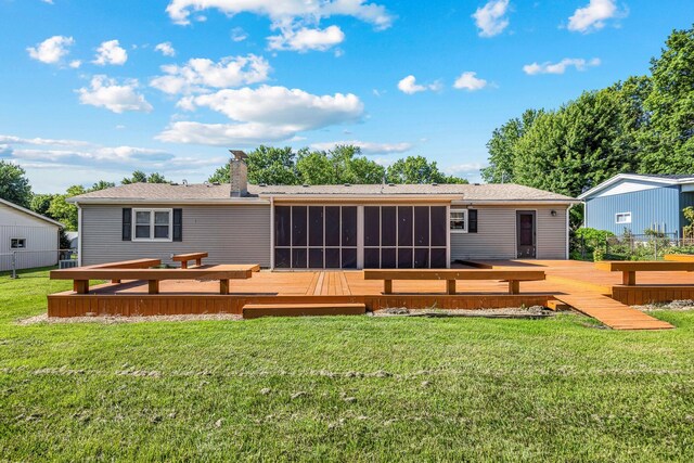 829 W Highland St, Springfield, MO 65807 - back of house with a sunroom, a wooden deck, a chimney, and a lawn