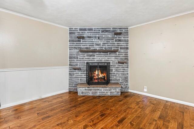 829 W Highland St, Springfield, MO 65807 - unfurnished living room featuring a fireplace, wood finished floors, crown molding, and wainscoting