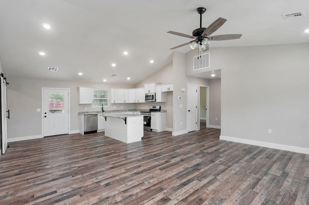 401 E Crescent St, Aurora, MO 65605 - kitchen with stainless steel appliances, open floor plan, white cabinets, a center island, and recessed lighting