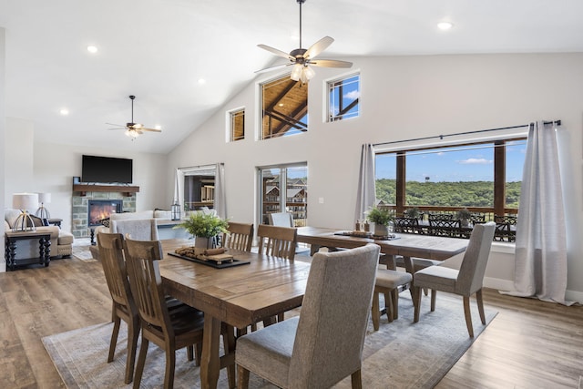 34 Shellie Ln, Branson, MO 65616 - dining area featuring ceiling fan, high vaulted ceiling, light wood-type flooring, a fireplace, and recessed lighting