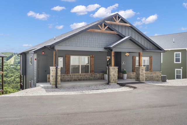 34 Shellie Ln, Branson, MO 65616 - craftsman house with a porch, stone siding, and board and batten siding