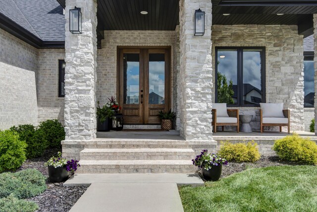 1510 N Lake Edge Dr, Springfield, MO 65802 - view of exterior entry featuring french doors, covered porch, and stone siding